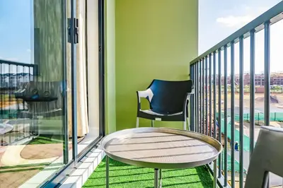 a balcony with a table and a chair at Alimama Spaces: The Manson's Green Creek in Pretoria