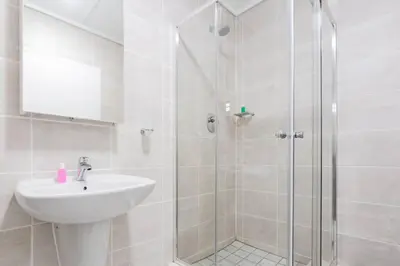 a bathroom with a sink and a shower at Alimama Spaces: The Manson's Green Creek in Pretoria
