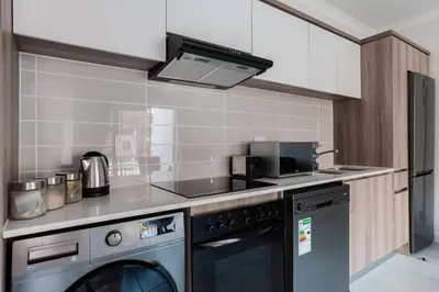 a kitchen with a stove and a dishwasher at #Alimama Spaces The Fountain Blyde in Pretoria