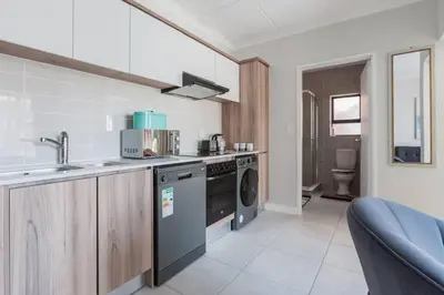 a kitchen with a sink and a dishwasher at #Alimama Spaces The Fountain Blyde in Pretoria