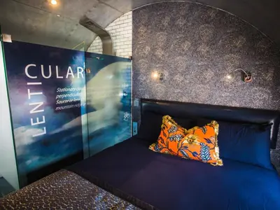 a bed in a room with a sign on the wall at Aerotel in Hoedspruit