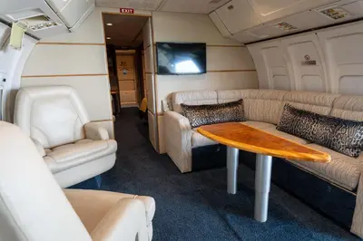 a living room in an rv with a table and chairs at Aerotel in Hoedspruit