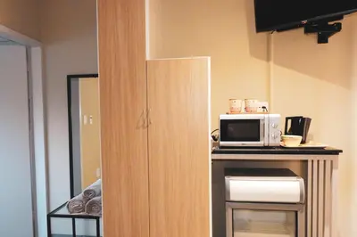 a kitchen with a microwave on top of a counter at Koemi Guest House in Kempton Park