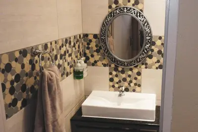 a bathroom with a sink and a mirror at Koemi Guest House in Kempton Park