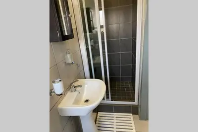 a bathroom with a sink and a shower at Centurion Fully furnished lock up&go 1 bedroom apartment in Centurion