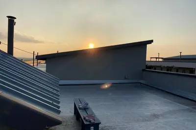 a building with a bench on the roof with the sunset at Centurion Fully furnished lock up&go 1 bedroom apartment in Centurion
