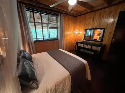 a bedroom with a bed and a television in it at Kruger Kumba - Lahlekile Nathi in Marloth Park