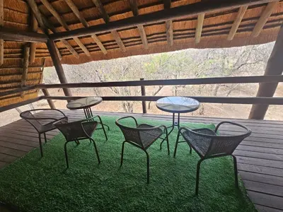 a group of chairs and tables on a patio at Inkwazi Place in Marloth Park
