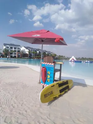 a beach with an umbrella and a surfboard on the sand at The Blyde Riverwalk Estate, R104 Bronkhorstspruit Road in Pretoria