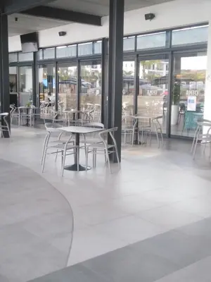 a cafeteria with tables and chairs and windows at The Blyde Riverwalk Estate, R104 Bronkhorstspruit Road in Pretoria