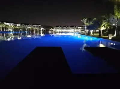 a large swimming pool at night with blue illumination at The Blyde Riverwalk Estate, R104 Bronkhorstspruit Road in Pretoria