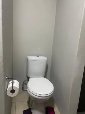 a bathroom with a white toilet in a stall at Ndzuti Guest House in Witbank