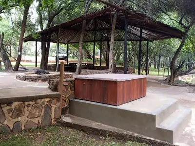 a wooden box sitting on a bench in a park at Wilgeboomsdrift Safaris in Modimolle