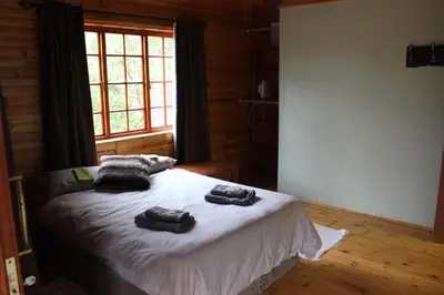 a bedroom with a bed with two towels on it at Wilgeboomsdrift Safaris in Modimolle