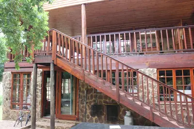 a wooden staircase on the side of a building at Wilgeboomsdrift Safaris in Modimolle