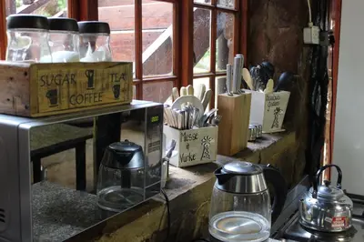 a counter with utensils in boxes and a window at Wilgeboomsdrift Safaris in Modimolle