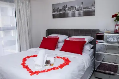 a bed with a heart made out of red pillows at The Blyde Riverwalk estate, Crystal Lagoon in Pretoria