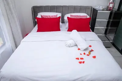 a bed with red pillows and red hearts on it at The Blyde Riverwalk estate, Crystal Lagoon in Pretoria