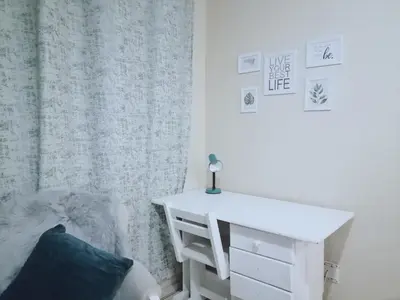 a bedroom with a white desk and a bed at Hatfield, Grosvenor Private apartment. in Pretoria
