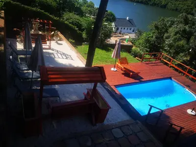 an overhead view of a swimming pool with a bench and chairs at Metsing at Harties in Hartbeespoort