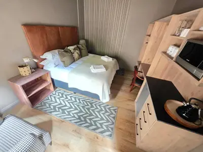 a small bedroom with a bed and a television at Migrate Portfolio in Dullstroom