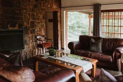 a living room with leather couches and a coffee table at Migrate Portfolio in Dullstroom