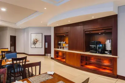 a lobby with a restaurant with a coffee bar at Garden Court Hatfield in Pretoria