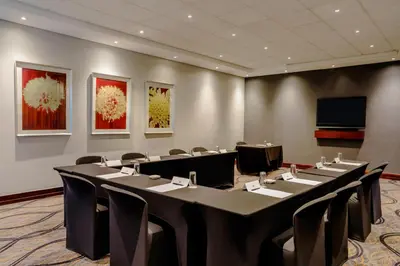 a conference room with a long table and chairs at Garden Court Hatfield in Pretoria
