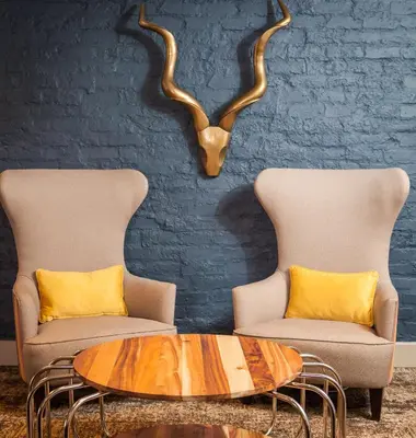 a living room with two chairs and a coffee table at Garden Court Polokwane in Polokwane