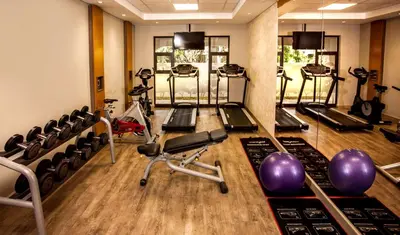 a gym with treadmills and elliptical machines at Garden Court Polokwane in Polokwane