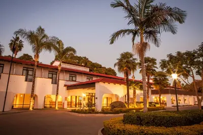 a building with palm trees in front of it at Garden Court Polokwane in Polokwane