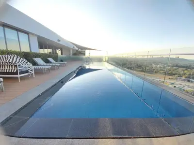 a swimming pool on the side of a building at Menlyn Apartment - Black Marble in Pretoria