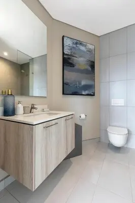a bathroom with a sink and a toilet at Menlyn Apartment - Black Marble in Pretoria