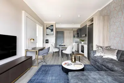 a living room with a couch and a table at Menlyn Apartment - Black Marble in Pretoria