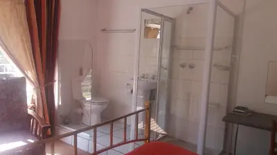 a bathroom with a shower and a toilet in it at Fouriestreet 199 Bed and Breakfast in Mokopane