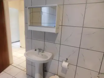 a white bathroom with a sink and a mirror at Fouriestreet 199 Bed and Breakfast in Mokopane