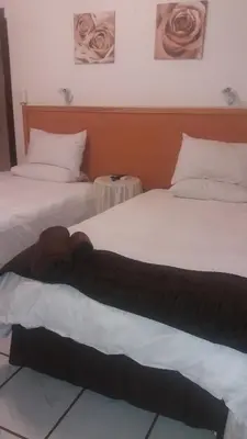 a teddy bear laying on top of two beds at Fouriestreet 199 Bed and Breakfast in Mokopane