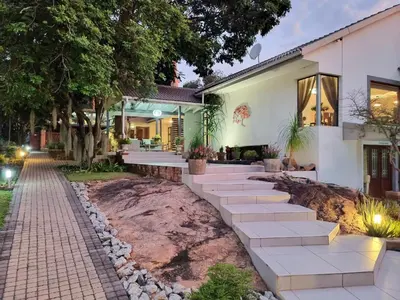 a house with stairs leading to the front yard at The Coral Tree in Nelspruit