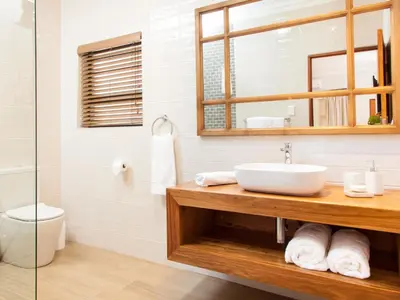 a bathroom with a sink and a mirror at The Coral Tree in Nelspruit