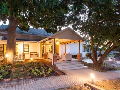 a house with a gazebo in the yard at The Coral Tree in Nelspruit