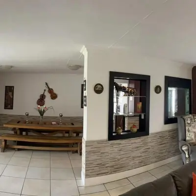 a living room with a couch and a table at Rustic red in Benoni