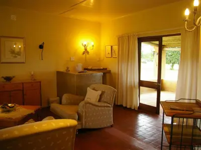 a living room with a couch and a chair at Bohm's Zeederberg Country House in Hazyview