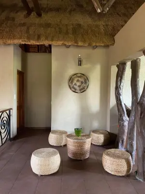 a room with four stools and a wall with a painting at Luna rossa 19 Zebula golf course and spa resort in Mabula