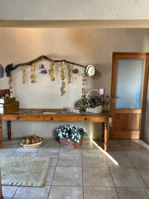 a room with a wooden bench and flowers on the wall at Luna rossa 19 Zebula golf course and spa resort in Mabula