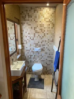 a bathroom with a toilet and a sink at Luna rossa 19 Zebula golf course and spa resort in Mabula