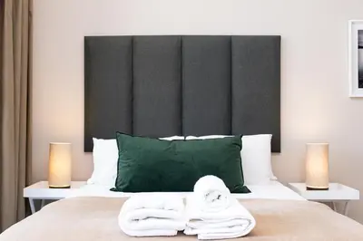 a bedroom with a bed with towels on it at Menlyn Residence - Studio Apartment in Pretoria
