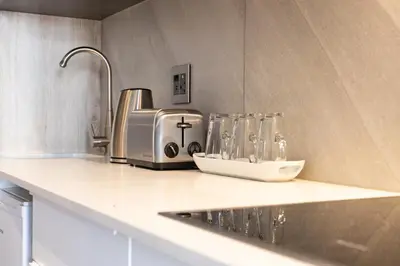 a kitchen counter with a sink and a toaster at Menlyn Residence - Studio Apartment in Pretoria