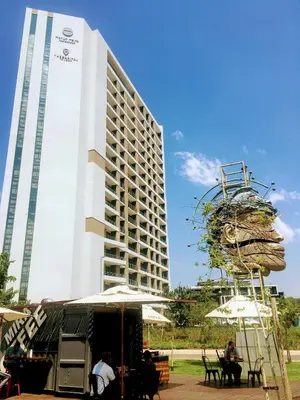 a tall building with people sitting in front of it at Menlyn Residence - Studio Apartment in Pretoria