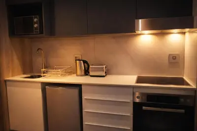 a kitchen with a sink and a counter top at Menlyn Apartment - Studio in Pretoria
