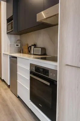 a kitchen with a stove and a sink at Menlyn Apartment - Studio in Pretoria